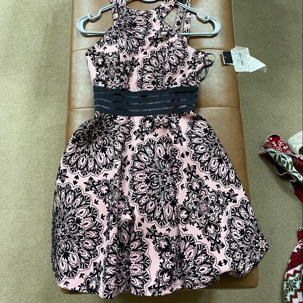 Junior size 1 dress brand new with tags. Pink with black velvet brocade detail.